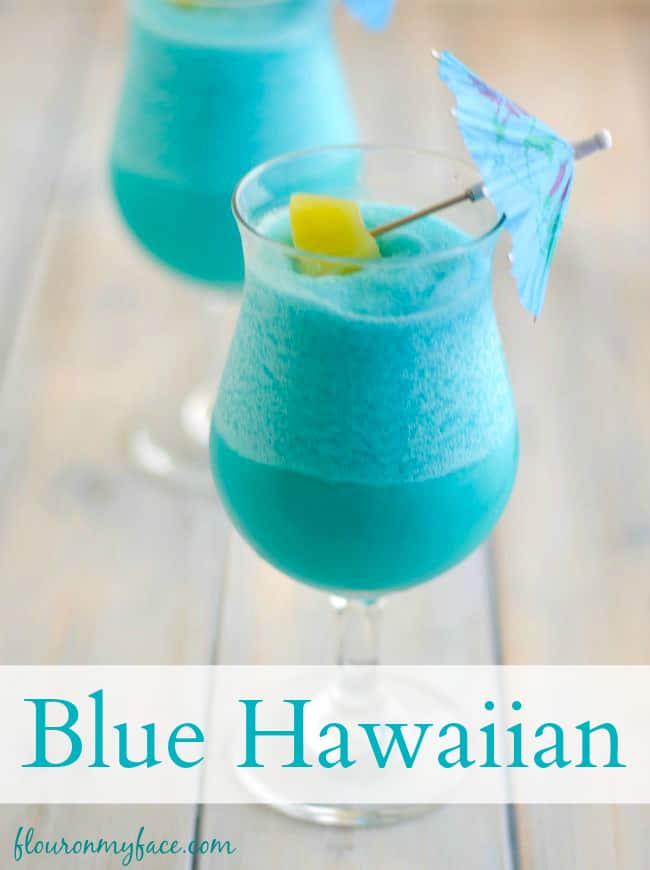 Frozen Blue Hawaiian Cocktail by Flour On My Face - Nothing screams summer more than frosty fruity drinks. Wine slushies, mules, sangria,  mimosas, cocktails, margaritas, and more! Graduations, Memorial Day, Fourth of July, or just a summer gathering with friends and family are all great reasons to throw a summer party.  No summer party is complete without fruity, slushy, cold drinks. You'll love these 10 summer drink recipes.  You'll be happy you tried them all. #summerdrinks #summerdrinkrecipes #foodanddrink #frozendrinks #wineslushies #frozencocktails #cocktails #partydrinks #partydrinkrecipes #HWS #healthywealthyskinny