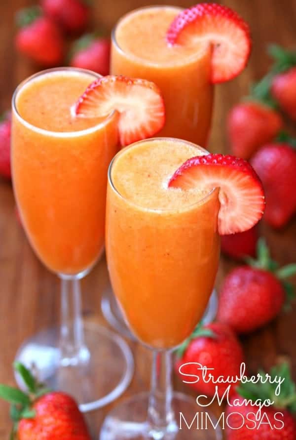 Strawberry Mango Mimosas by Happy Go Lucky - Nothing screams summer more than frosty fruity drinks. Wine slushies, mules, sangria,  mimosas, cocktails, margaritas, and more! Graduations, Memorial Day, Fourth of July, or just a summer gathering with friends and family are all great reasons to throw a summer party.  No summer party is complete without fruity, slushy, cold drinks. You'll love these 10 summer drink recipes.  You'll be happy you tried them all. #summerdrinks #summerdrinkrecipes #foodanddrink #frozendrinks #wineslushies #frozencocktails #cocktails #partydrinks #partydrinkrecipes #HWS #healthywealthyskinny