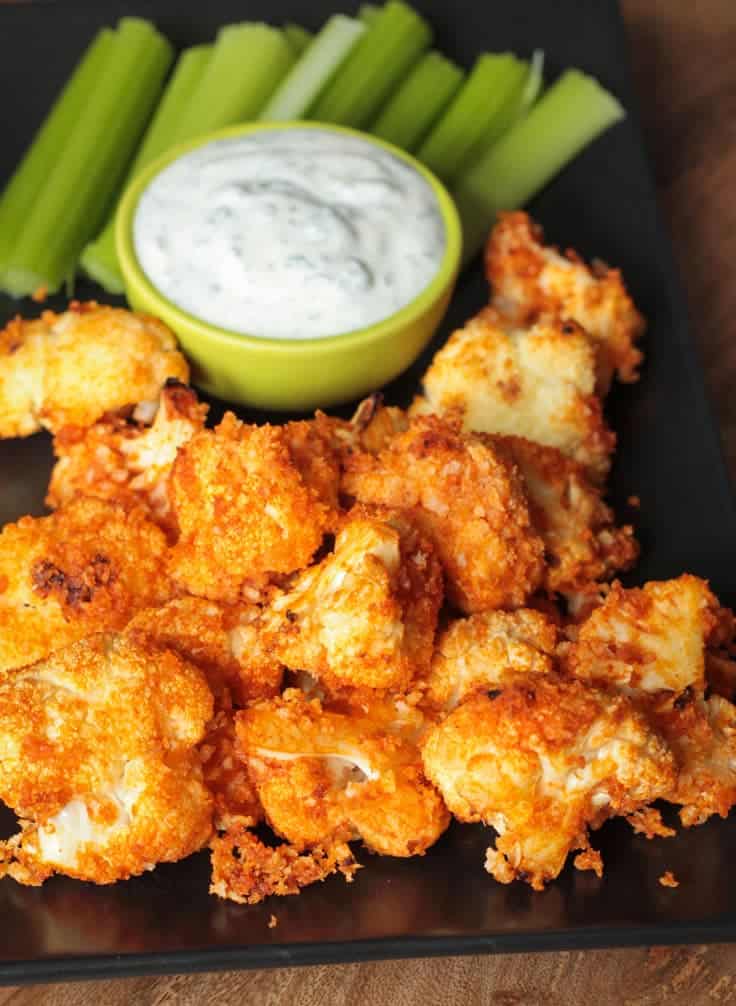 Buffalo Cauliflower Bites by Veggie Inspired | Super Bowl Party Food Ideas for your next super bowl party. Get Super Bowl recipes for appetizers, main dishes, chicken wings, drinks and cocktails. Find party food recipes to make your football party a crowd favorite. #superbowl #partyfood #partyrecipes #foodanddrink #superbowlparty #HWS #healthywealthyskinny
