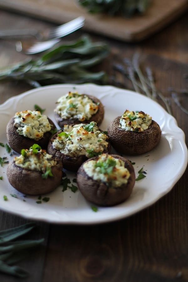 Herb and Goat Cheese Stuffed Mushrooms by The Roasted Root | Super Bowl Party Food Ideas for your next super bowl party.  Get Super Bowl recipes for appetizers, main dishes,  chicken wings, drinks and cocktails. Find party food recipes to make your football party a crowd favorite. #superbowl #partyfood #partyrecipes #foodanddrink #superbowlparty #HWS #healthywealthyskinny